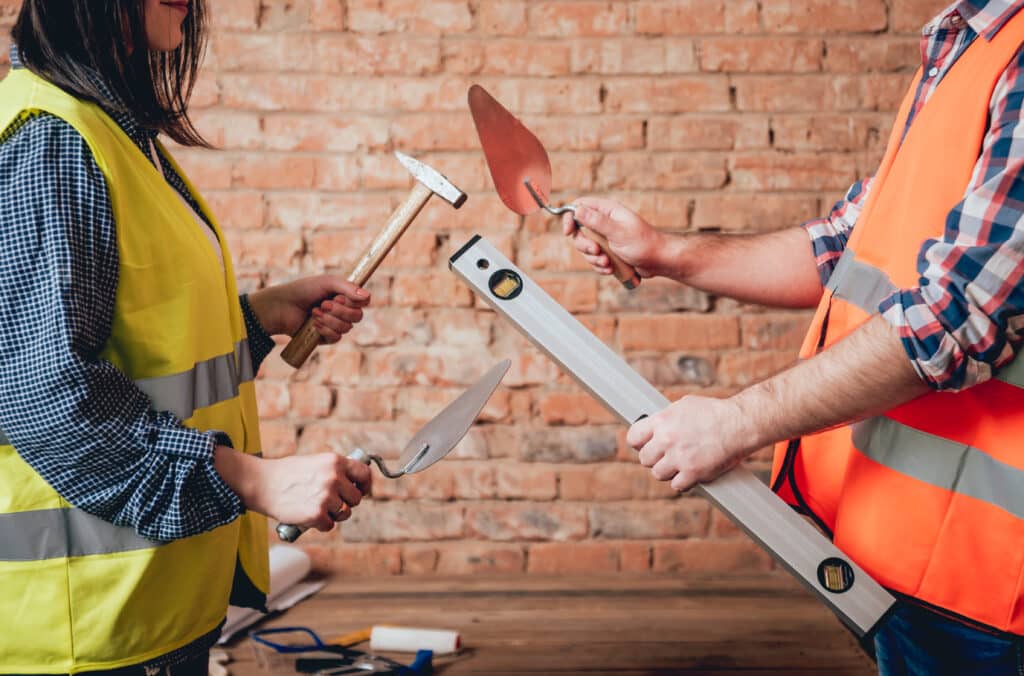 Hands holding tools for home renovation. Concept